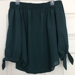 Green off-the-shoulder shirt.